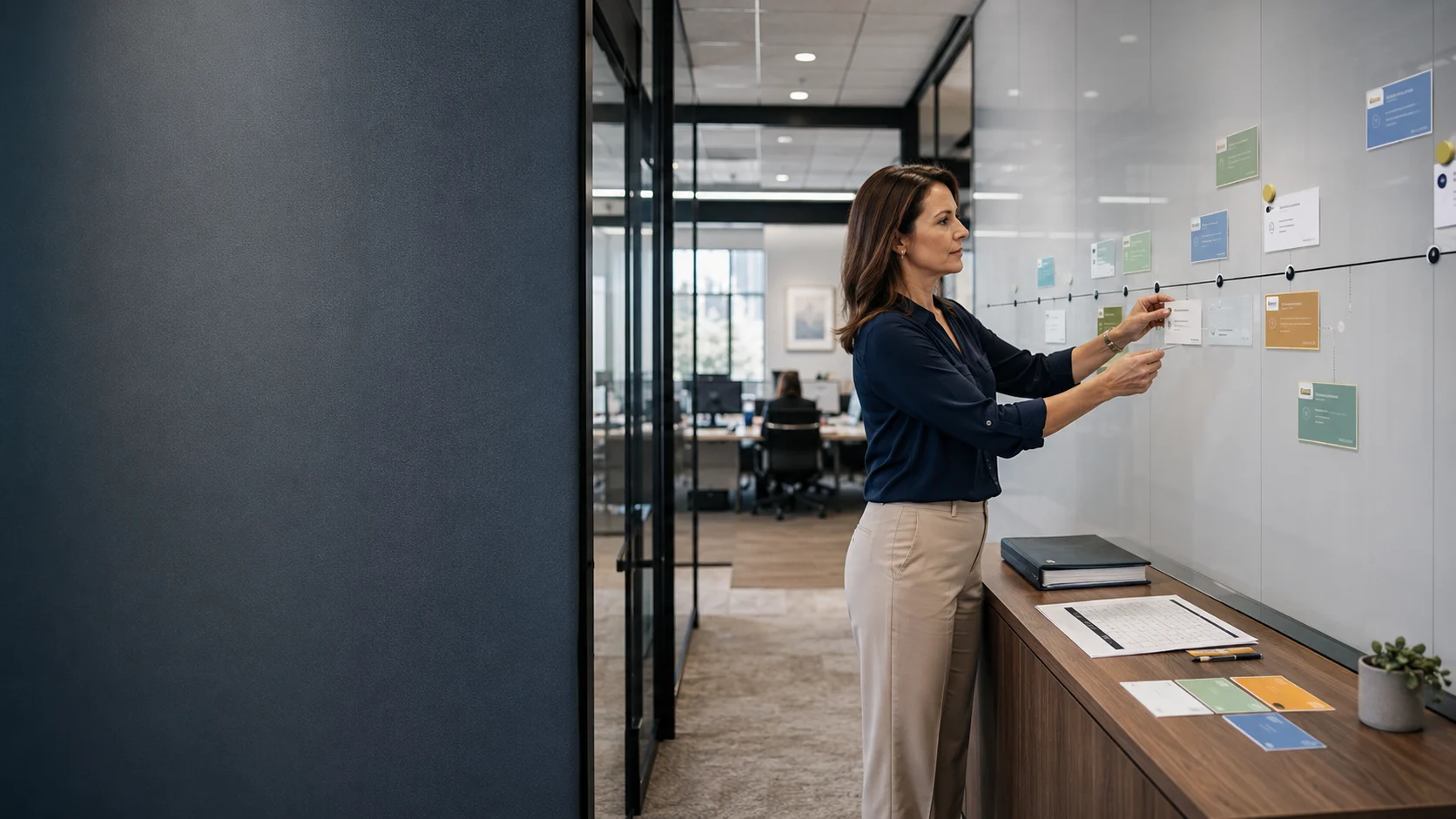 HR leader organizing an employee-benefits renewal timeline in a professional office well before quotes arrive.