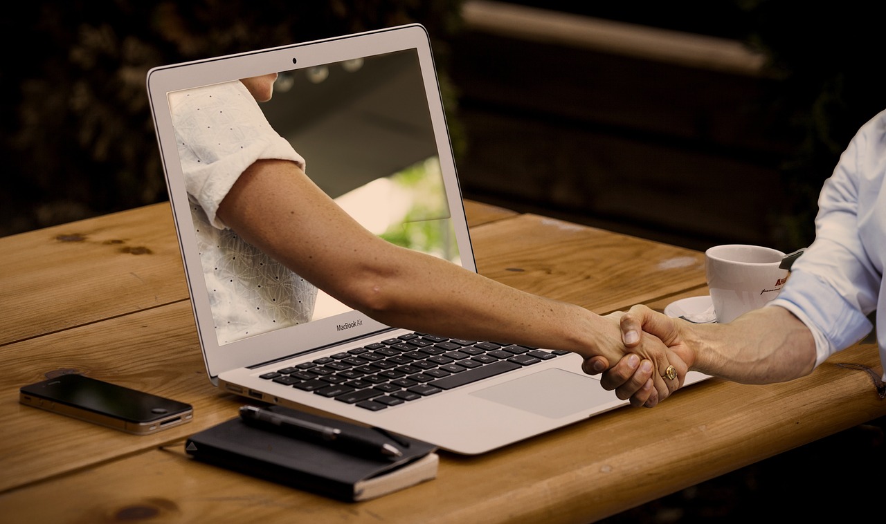 Remote HR team collaborating on outsourced human resources services via laptop